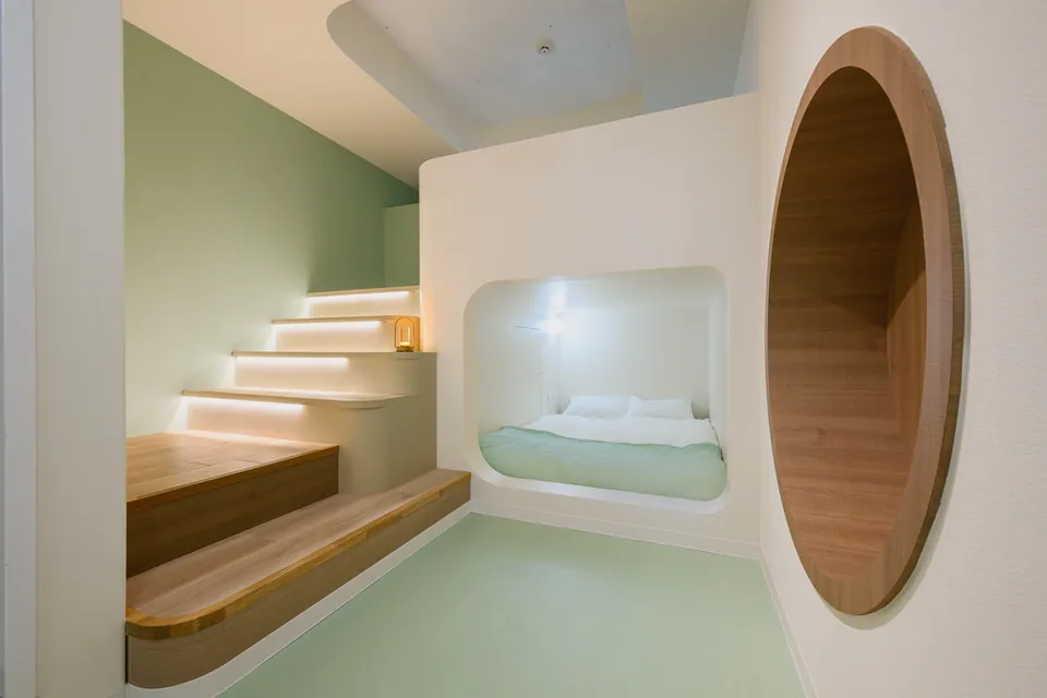 The cosy nook with a round wooden entrance at ARiA STAY HATSUDAI
