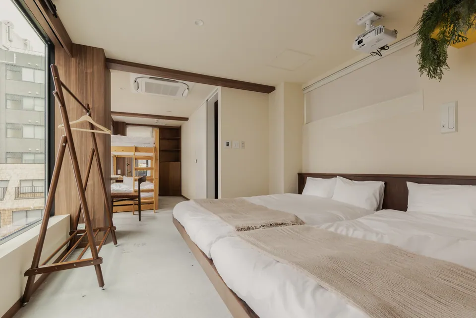 The bright bedroom and wooden bunk bed at Komorebi Stay