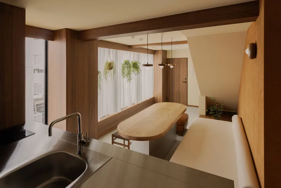 The view from the kitchen into the wooden dining space at Komorebi Stay