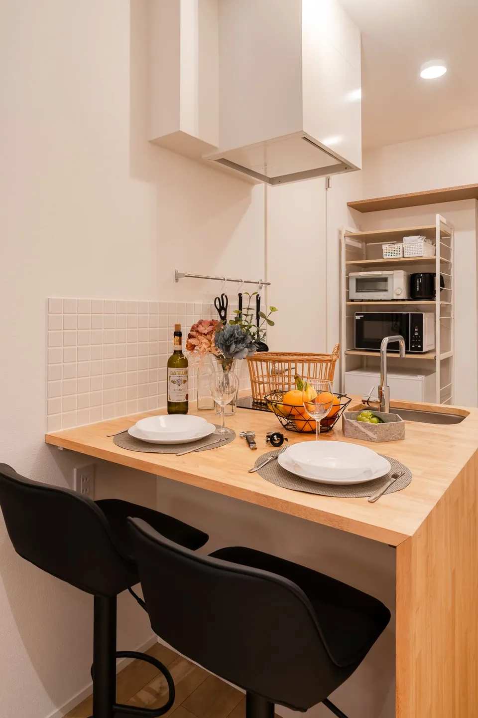 The kitchen counter and black stools in SB3A