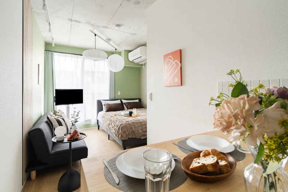 SB3B: Olive & wood. Pale olive walls, wood slats and round white lights create a calm space for a small group.